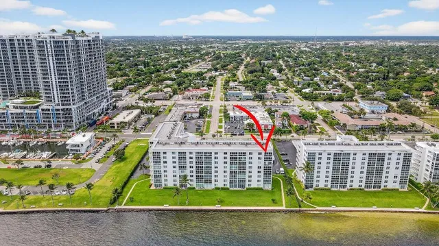 a view of a kitchen with a sink and living room view