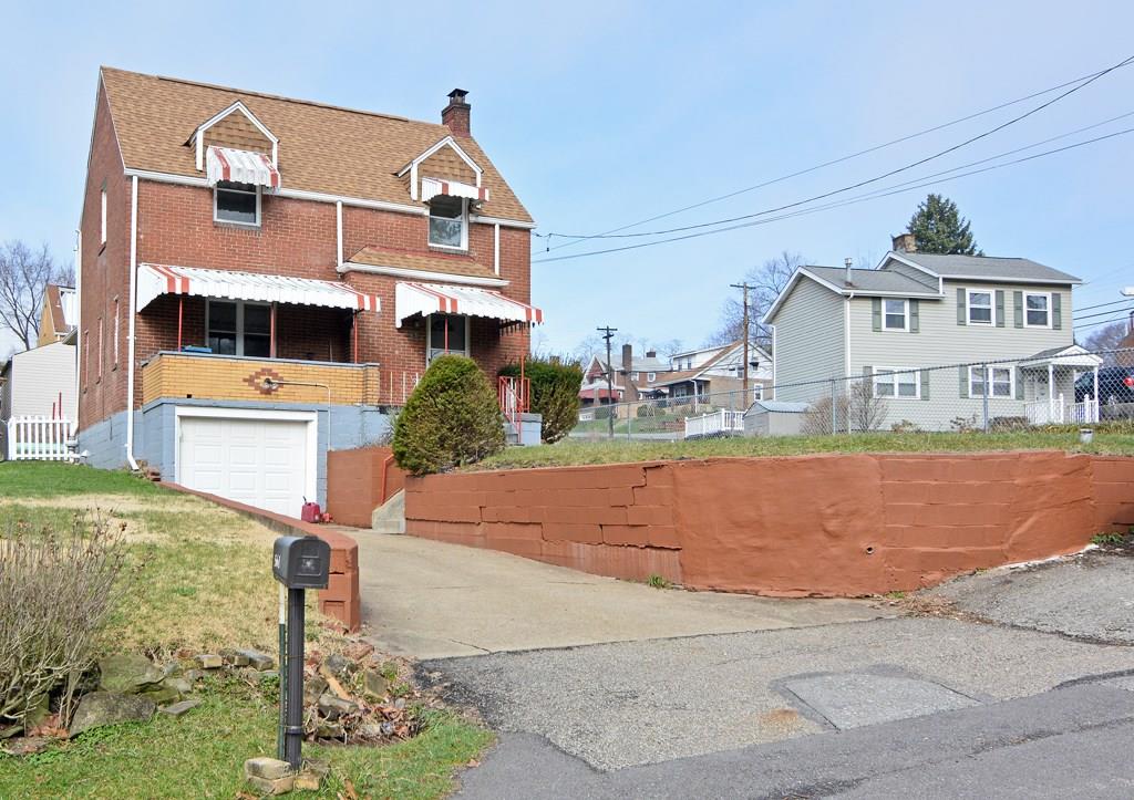 561 Keystone Street Pittsburgh, PA 15215 - Photo 2 of 10 A one-car integral garage and long driveway offers ample parking space.