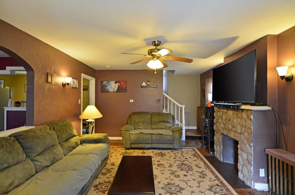 561 Keystone Street Pittsburgh, PA 15215 - Photo 3 of 10 The front entry opens into the spacious living room, highlighted by a stone-front fireplace, hardwood flooring, lighted ceiling fan and arched pass-through to the dining room.