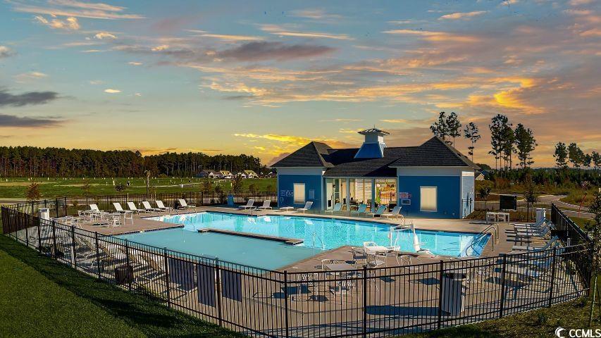 2162 Gooseberry Way Longs, SC 29568 - Photo 29 of 34 Pool at dusk featuring a patio and a community pool