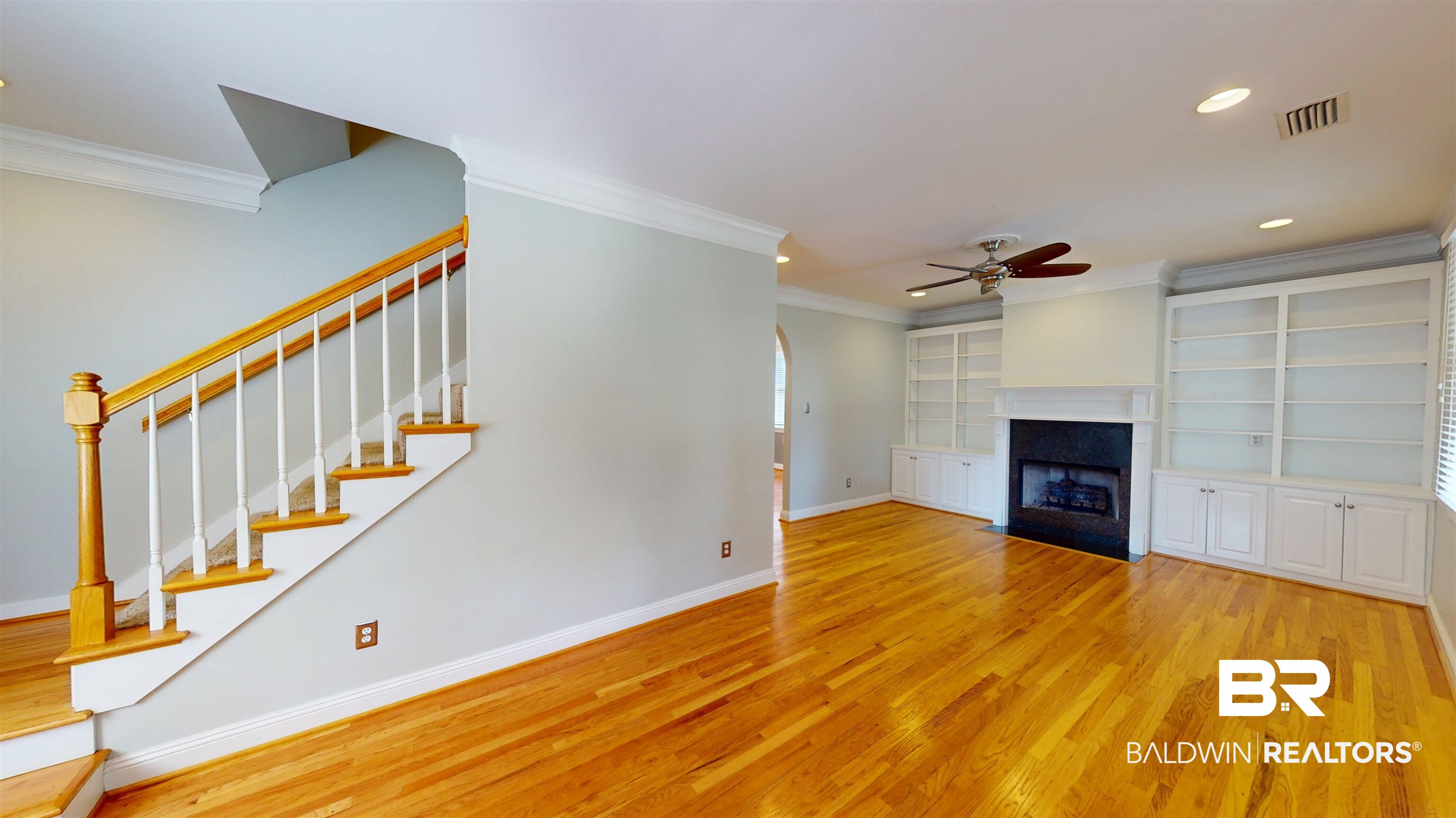 1651 Laurel Street Mobile, AL 36604 - Photo 3 of 28 Unfurnished living room with ceiling fan, baseboards, crown molding, wood finished floors, and stairway
