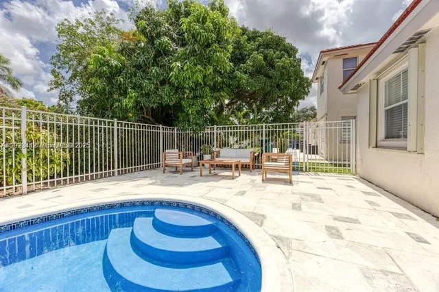an aerial view of lake and residential houses with outdoor space