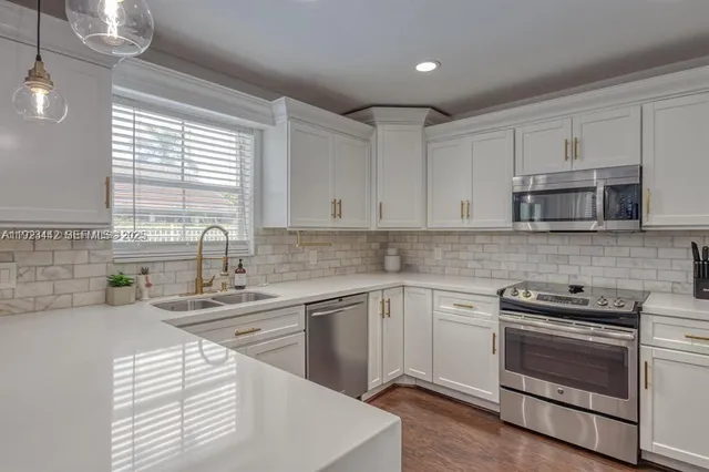 a kitchen with appliances cabinets and a sink