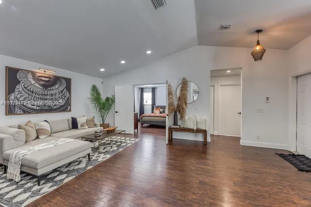 a living room with furniture and wooden floor