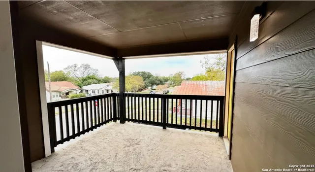 a view of balcony with a floor to ceiling window and wooden floor