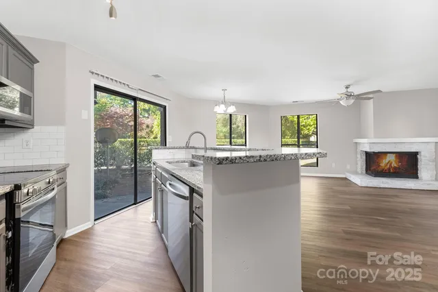 a kitchen with granite countertop a stove and a refrigerator