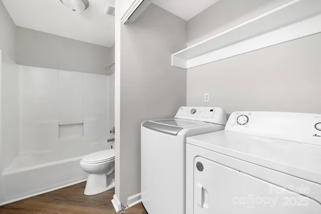 a view of bathroom with a washer and dryer