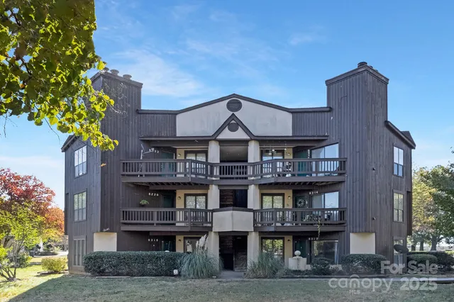 a view of a large building with a tree and windows
