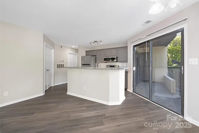a view of a kitchen with wooden floor