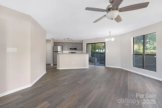 a view of a kitchen with a microwave and wooden floor