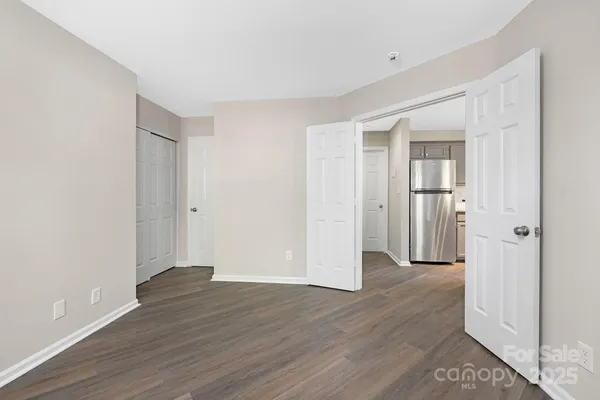 a view of an empty room with wooden floor