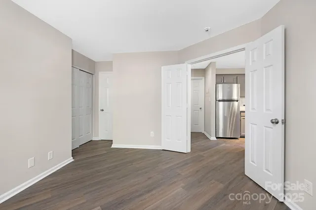 a view of an empty room with wooden floor