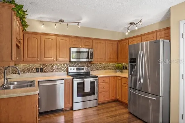 a kitchen with a sink cabinets and window