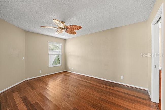 2 Misners Trail Ormond Beach, FL 32174 - Photo 14 of 44 an empty room with wooden floor and windows