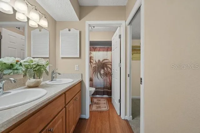 a white toilet sitting next to a shower curtain