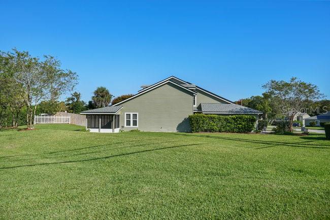2 Misners Trail Ormond Beach, FL 32174 - Photo 30 of 44 a front view of house with yard and trees in the background