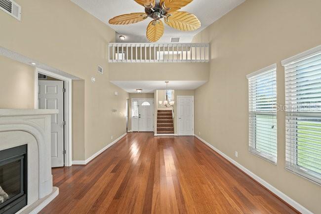 2 Misners Trail Ormond Beach, FL 32174 - Photo 7 of 44 a view of an empty room with wooden floor fireplace and a window