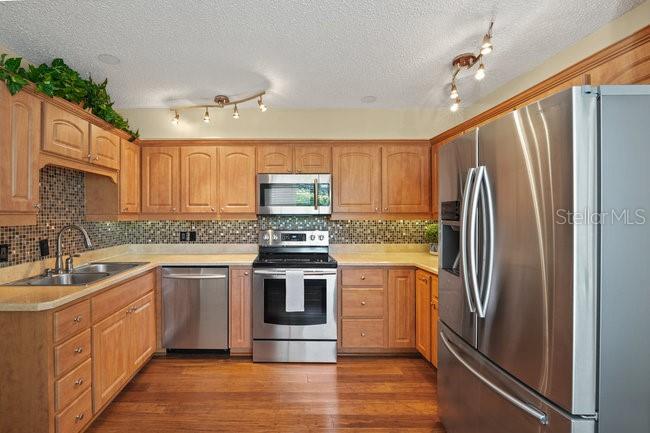 2 Misners Trail Ormond Beach, FL 32174 - Photo 10 of 44 a kitchen with stainless steel appliances granite countertop a refrigerator sink and cabinets