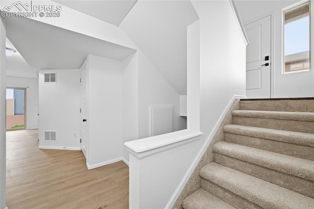 9414 Timberlake Loop Colorado Springs, CO 80927 - Photo 22 of 40 Lower level stairs with light luxury vinyl wood-style floors