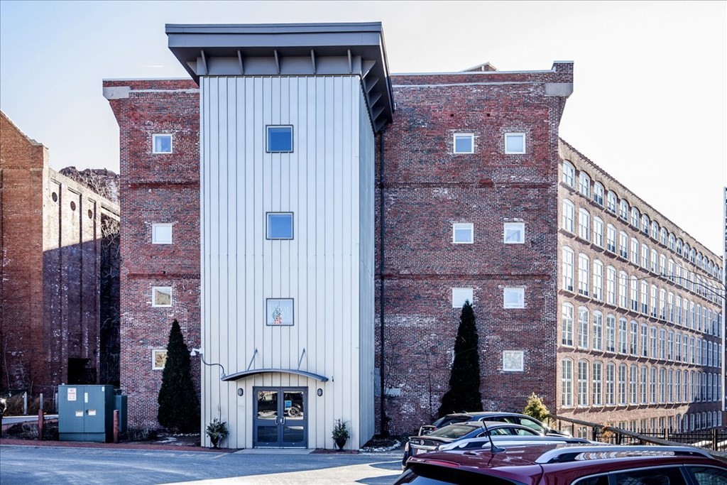 200 Market Street, Unit 3010 Lowell, MA 01852 - Photo 1 of 26 a front view of a building with glass windows