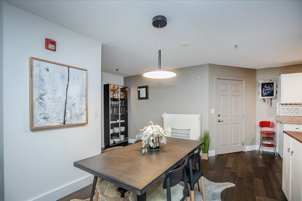 200 Market Street, Unit 3010 Lowell, MA 01852 - Photo 12 of 26 a view of a dining room with furniture and wooden floor
