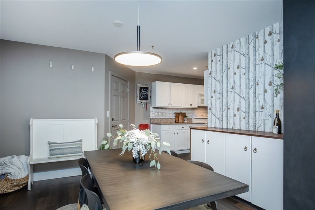 200 Market Street, Unit 3010 Lowell, MA 01852 - Photo 13 of 26 a kitchen with a table chairs and white cabinets