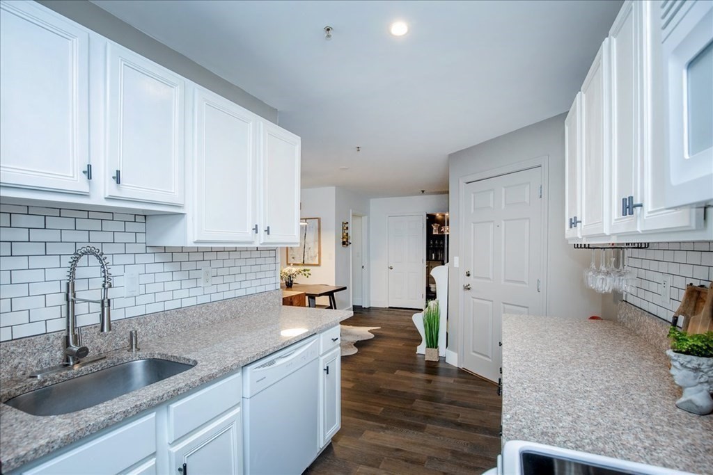 200 Market Street, Unit 3010 Lowell, MA 01852 - Photo 7 of 26 a kitchen with a sink and white cabinets