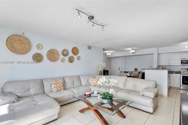 a living room with furniture and kitchen view