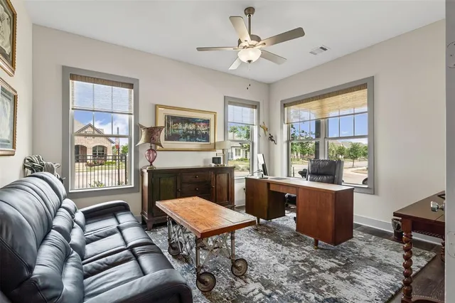 a living room with furniture a table and large window