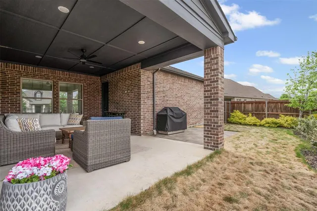 a view of a porch with furniture and a fire pit