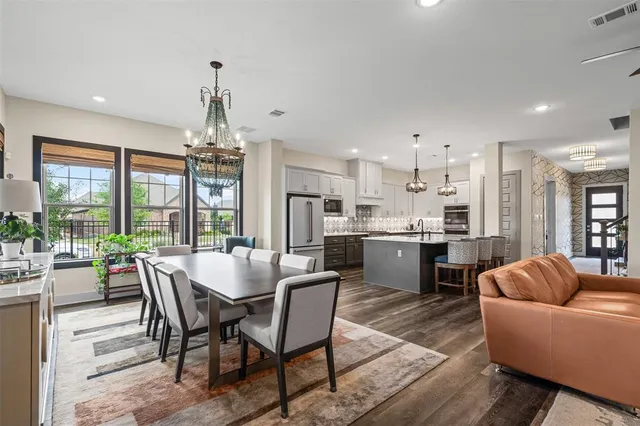 a view of a dining room with furniture large windows and wooden floor