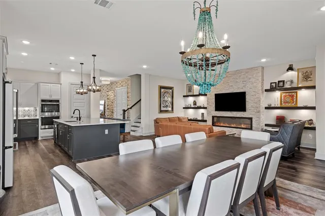 a living room with dining table furniture and a flat screen tv