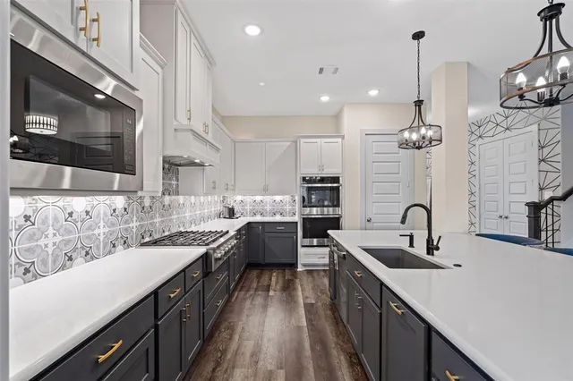 a kitchen with a sink stove and cabinets