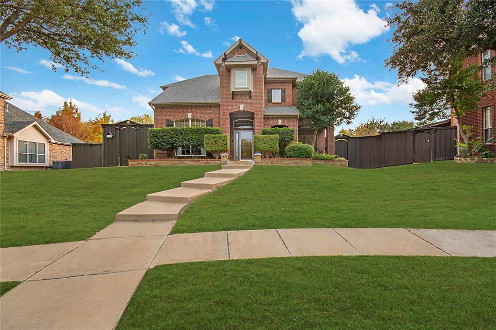 11601 Forestbrook Drive Frisco, TX 75035 - Photo 2 of 40 a front view of a house with a yard and garage