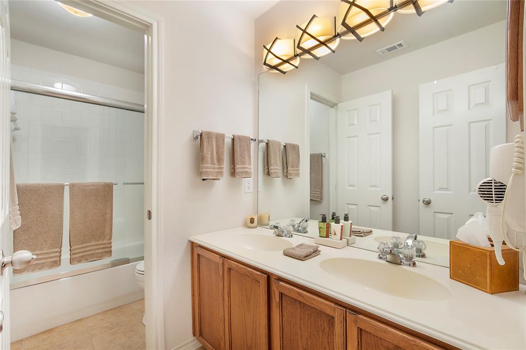 11601 Forestbrook Drive Frisco, TX 75035 - Photo 30 of 40 a bathroom with a sink vanity granite and shower
