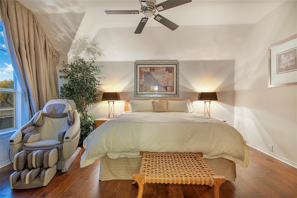 11601 Forestbrook Drive Frisco, TX 75035 - Photo 33 of 40 a bed sitting in a bedroom next to a window and a chandelier