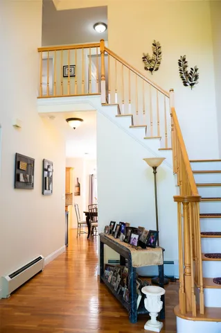 a living room with wooden floor and stairs