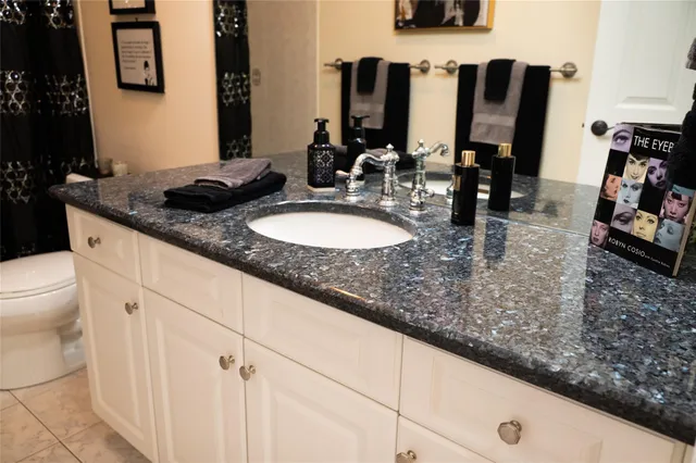 a bathroom with a double vanity sink and a mirror