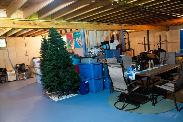 a kitchen with granite countertop wooden floor dining table and stainless steel appliances