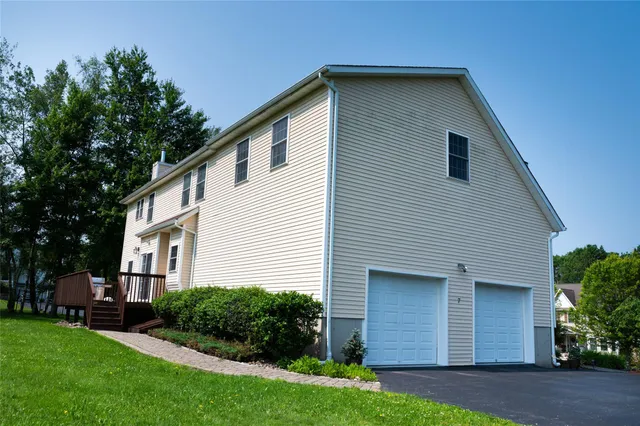 a front view of a house with a yard and flowers