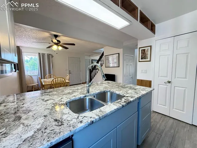 a kitchen with a sink and a refrigerator