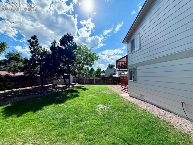 a view of a backyard with sitting area
