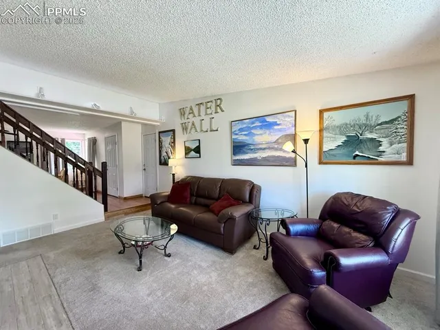 a living room with furniture and a rug