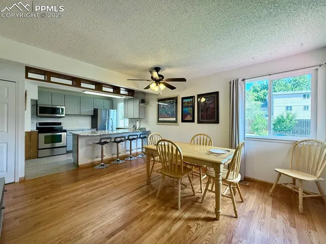 a view of a dining room with furniture and wooden floor