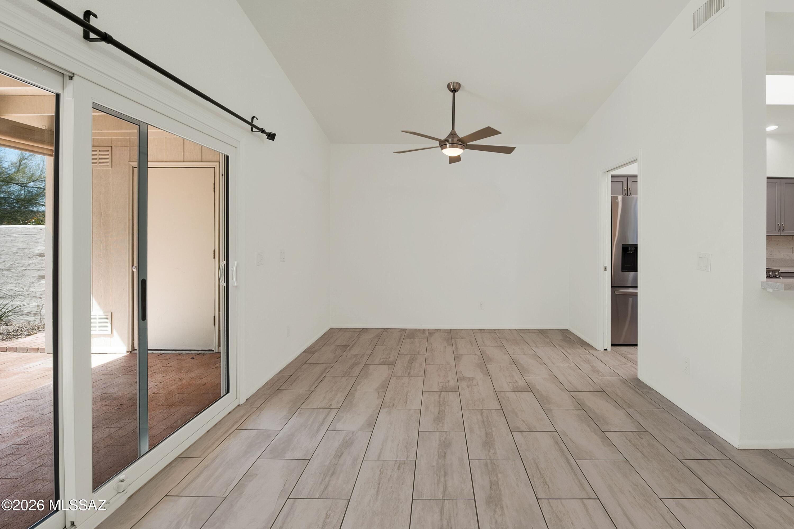 7408 East Wandering Road Tucson, AZ 85750 - Photo 10 of 25 a view of empty room with wooden floor and fan