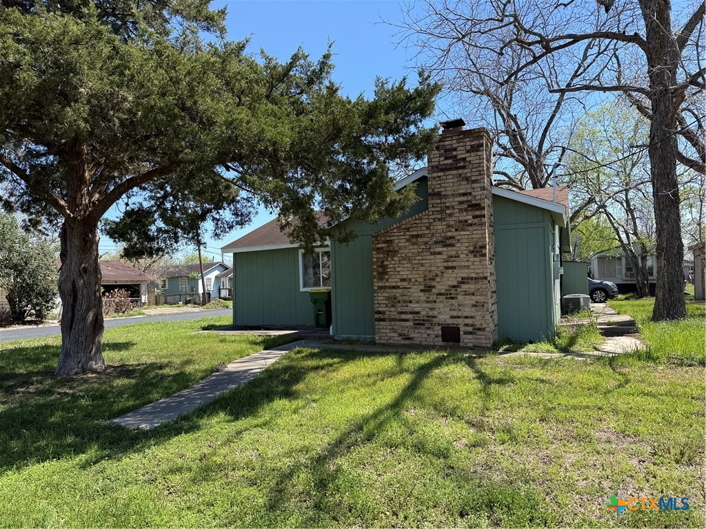 a view of a backyard with a large tree