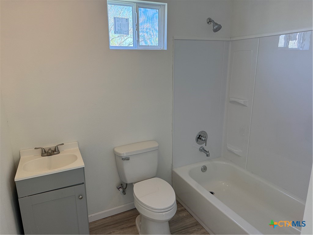 2411 Mumphord Street Victoria, TX 77901 - Photo 11 of 17 a white toilet sitting next to a bath tub