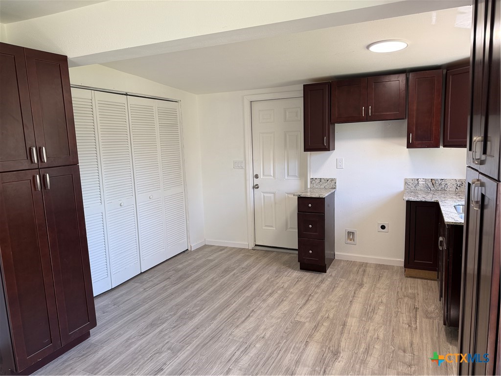 2411 Mumphord Street Victoria, TX 77901 - Photo 4 of 17 a view of a kitchen with furniture and a refrigerator