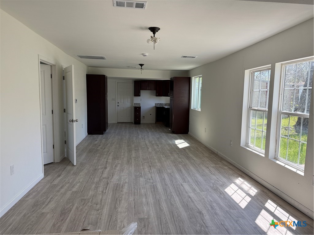 2411 Mumphord Street Victoria, TX 77901 - Photo 6 of 17 a view of a room with wooden floor electronic appliances and window