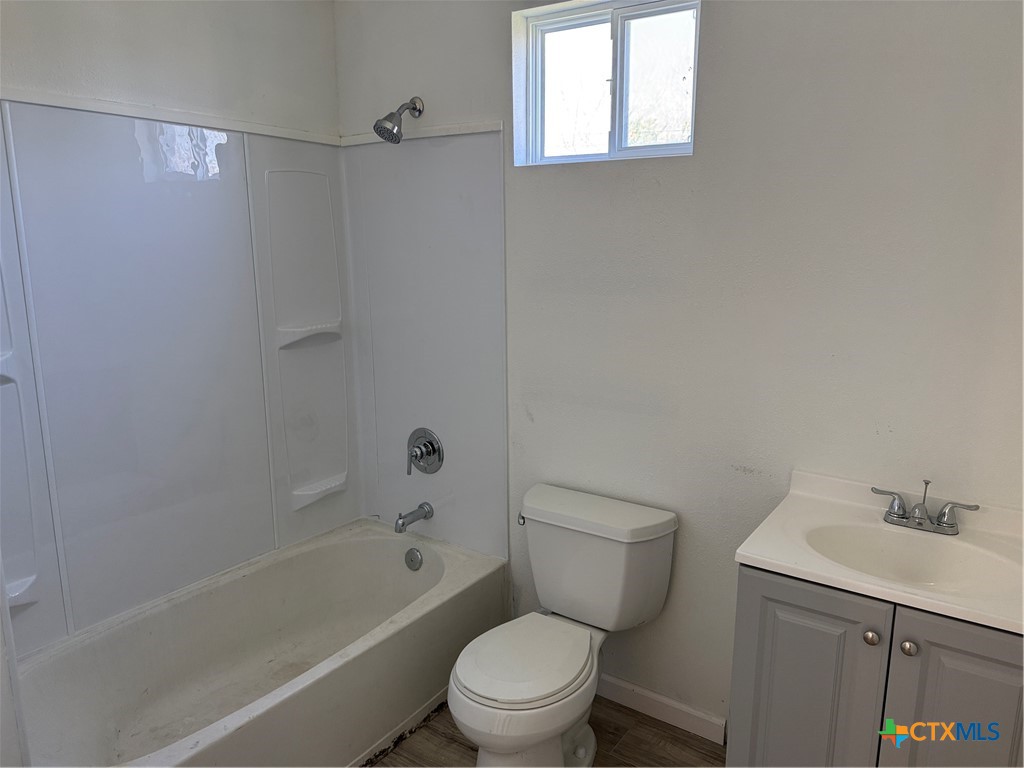 2411 Mumphord Street Victoria, TX 77901 - Photo 7 of 17 a white toilet sitting next to a bath tub